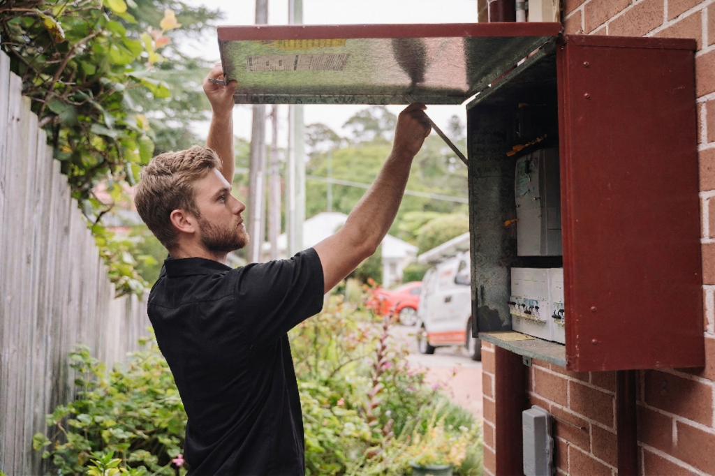 Electrician installing downlights in a Glenhaven home